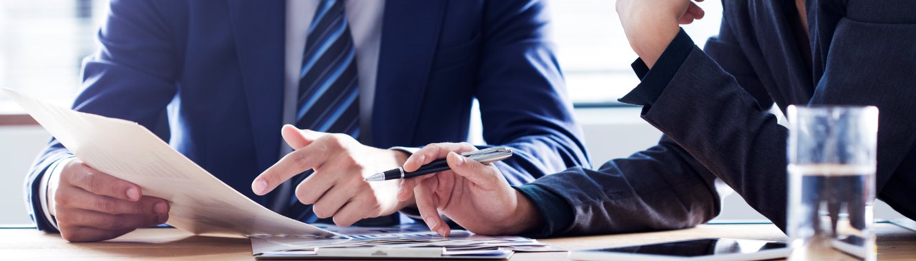 Two business people discussing a document.