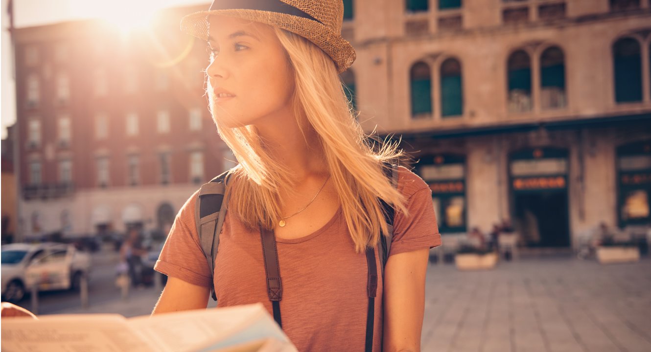 Young woman holding a map.