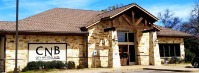 White and brown stone building with large doors and windows. Quitman Branch