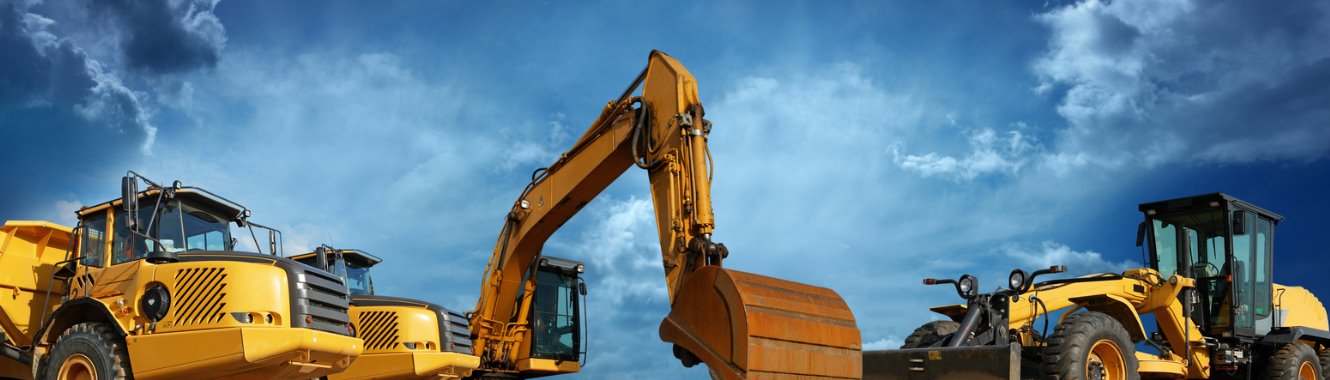 heavy machinery with dark clouds in the sky 