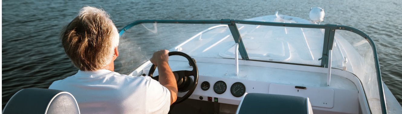 Adult male driving a boat