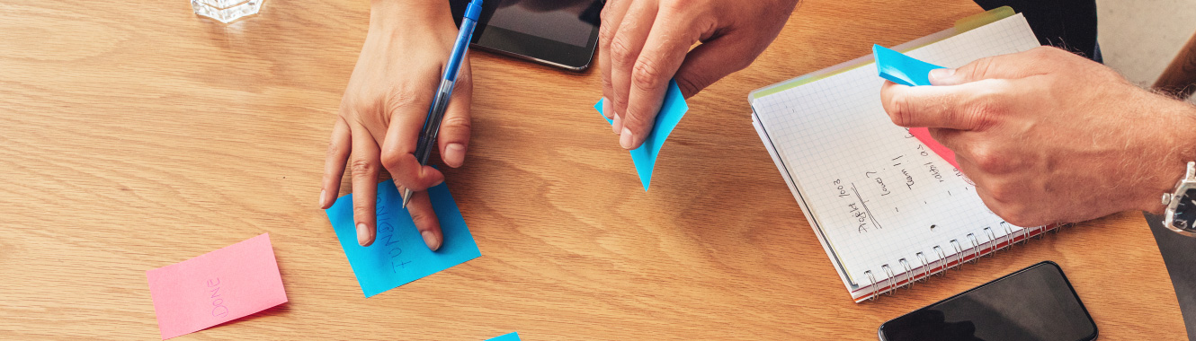 Small business owners brainstorming with sticky notes